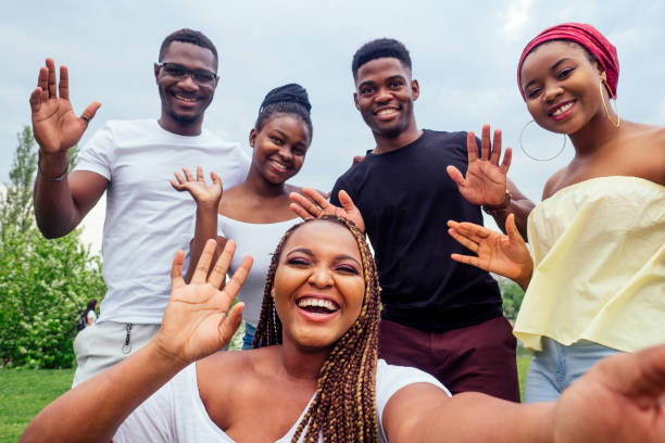 istockphoto-1403940926-612x612 group of five friends female and male taking selfie on camera smartphone and having fun outdoors lifestyle near lake